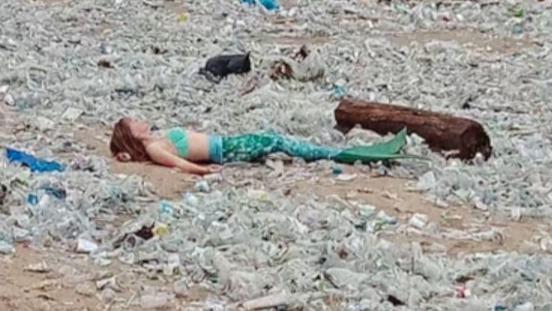 The Litter Mermaid! Costumed Mermaid Pictured Laying On Indonesian Beach Amongst Piles Of Trash! | Khou.com