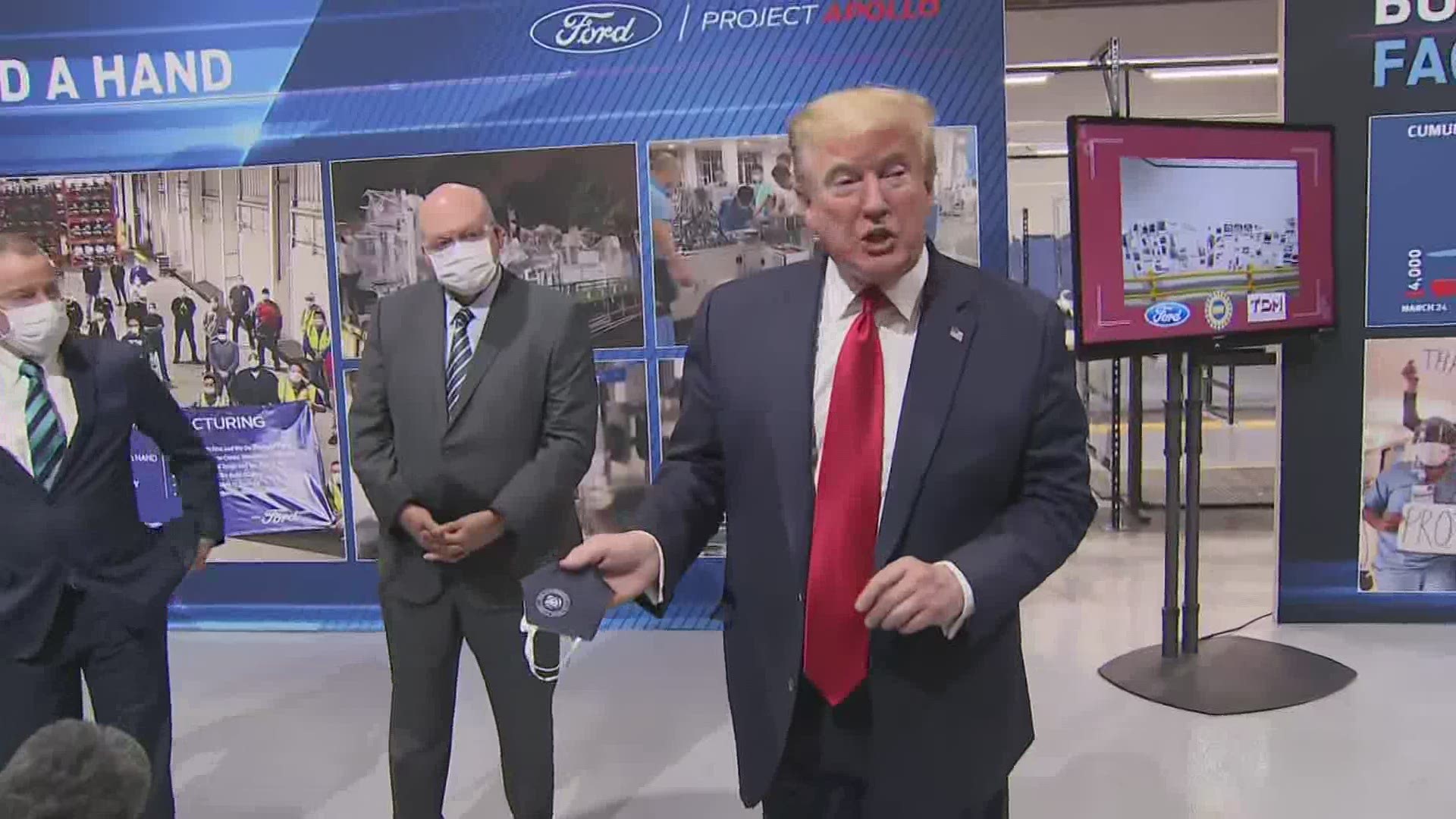 The president showed reporters the mask he said he wore on a visit to a Ford plant in Michigan, saying he might look 'better' with it on.