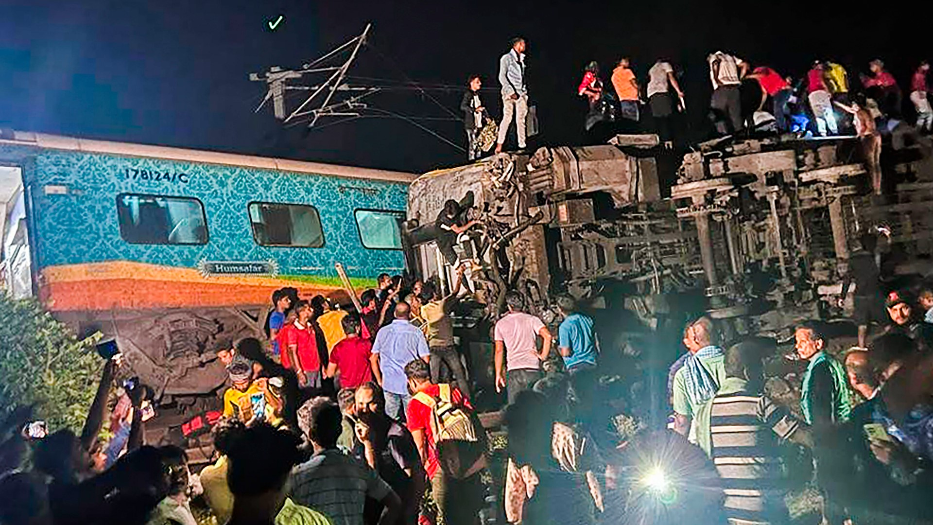 Two passenger trains derailed Friday night in India, killing more than 230 people and leaving hundreds of others trapped inside.