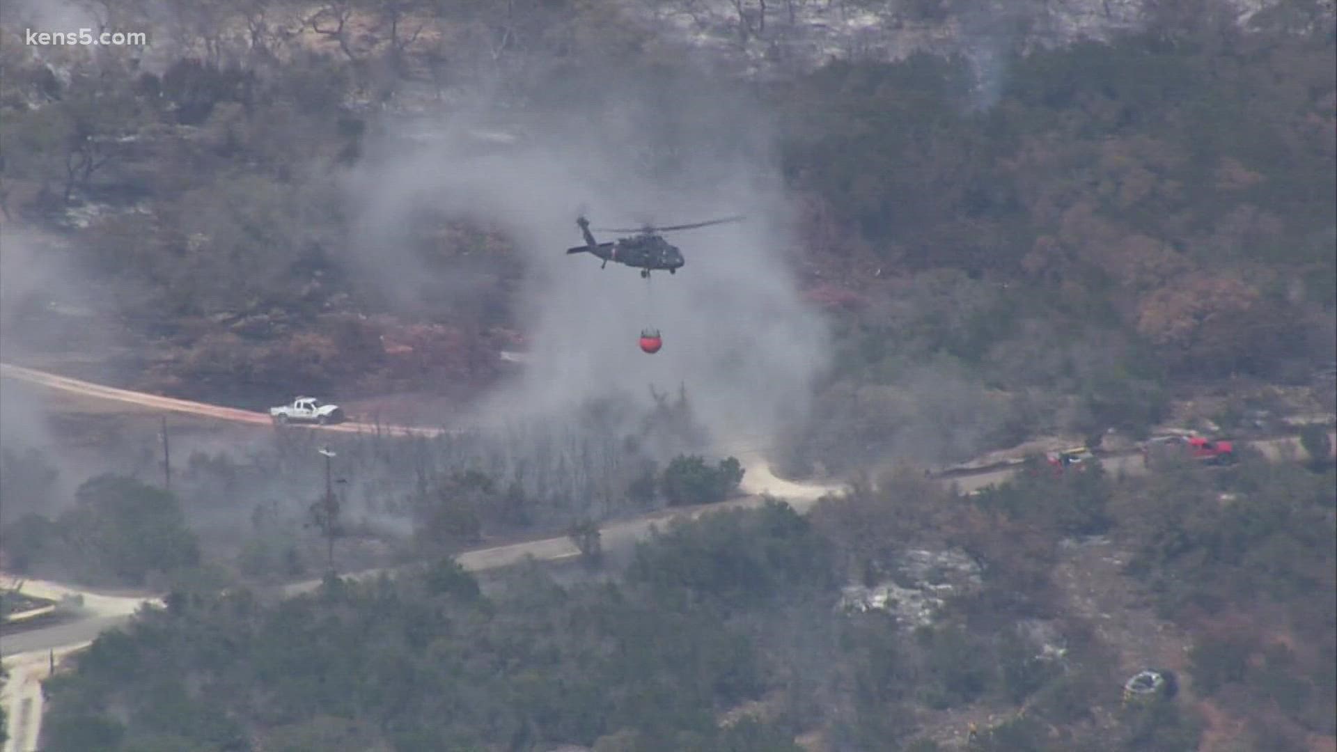 Residents anxiously wait to return home as multiple agencies work to contain fire near Medina Lake.