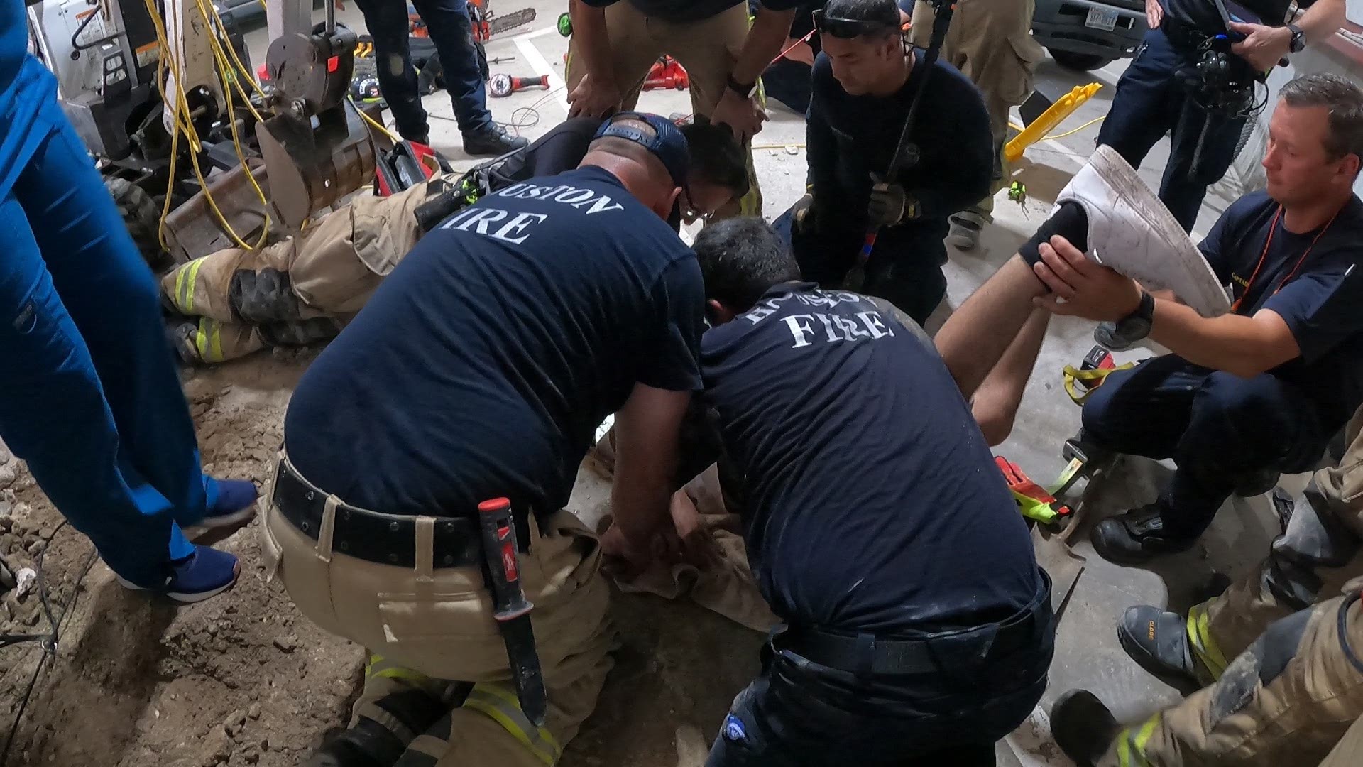 An adorable, black pup who got himself stuck in an underground pipe was rescued with the help of a team of Houston firefighters.
