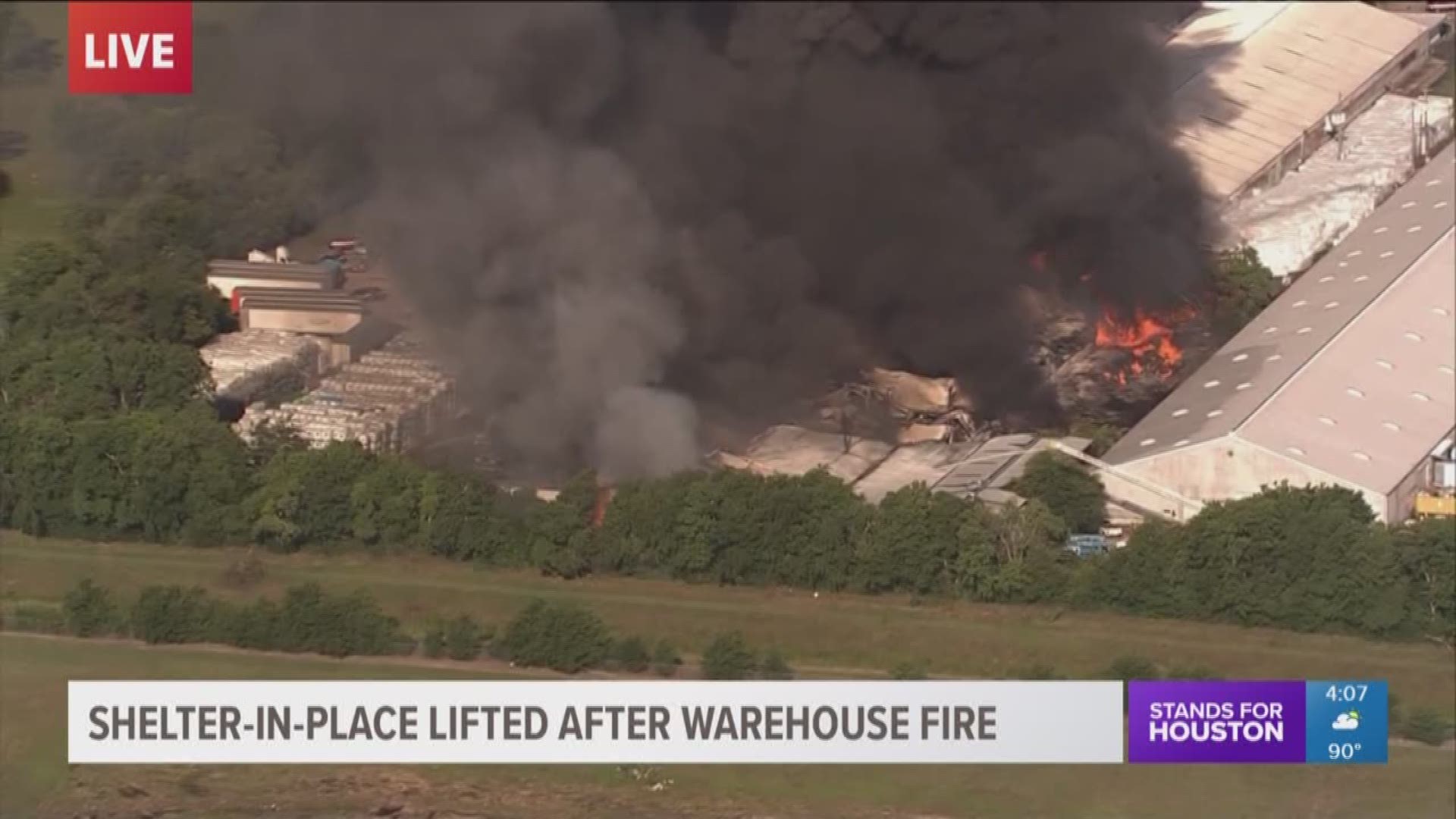 A shelter in place has been lifted following a massive four-alarm fire at a plastic tote recycling business in south Houston on Monday.