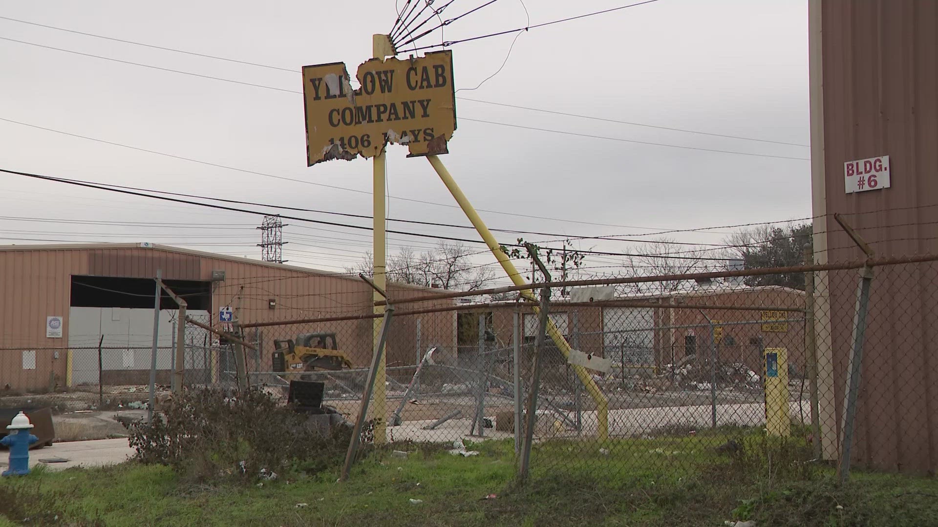 Mounds of trash are being removed at a Near Northside property. Residents worked for months to bring attention to the eyesore.