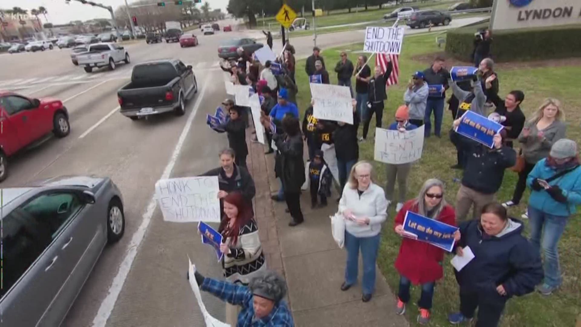 Employees who work for NASA and TSA rallied outside the Johnson Space Center on Tuesday in protest of the ongoing government shutdown.