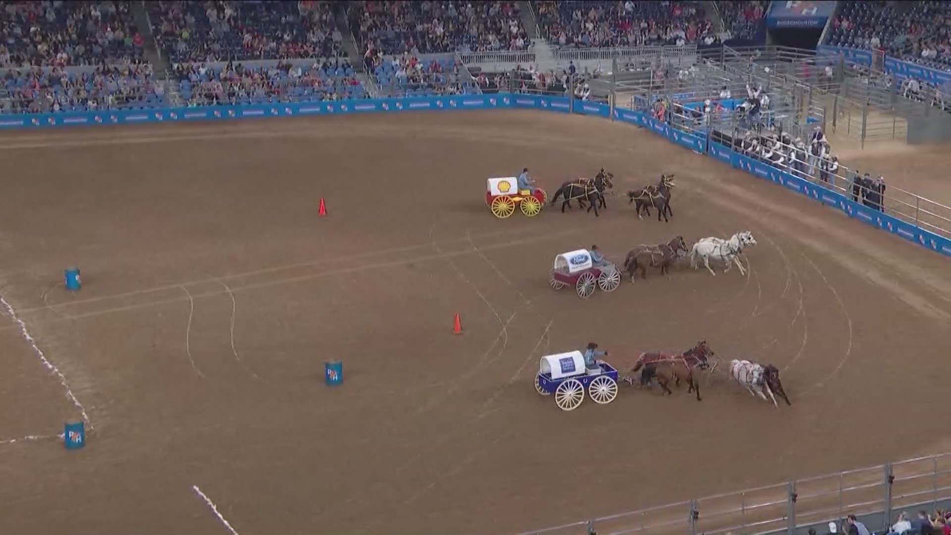 The chuck wagon races featuring Houston businesses and organizations take place after the rodeo competition and before the concert.