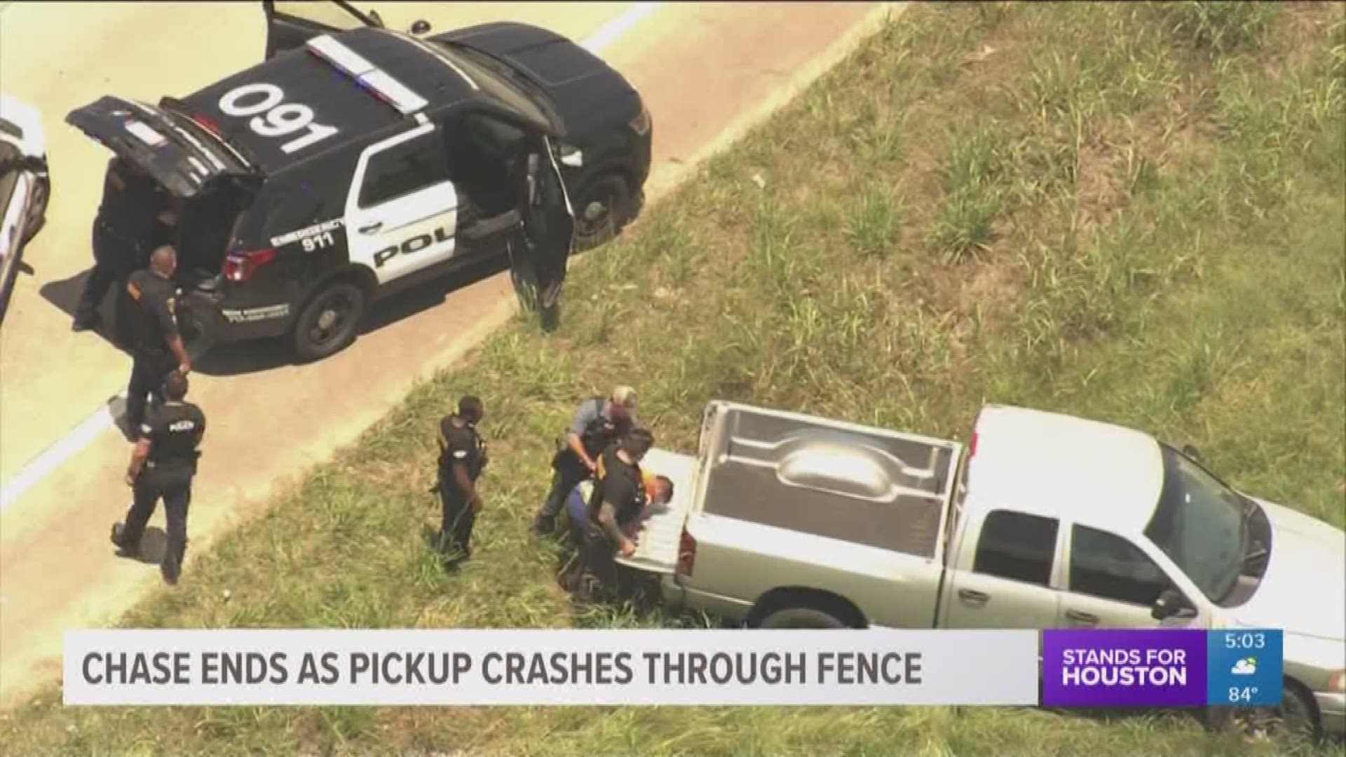 A man in a pick-up truck led police on a 15-minute chase Wednesday that ended when he crashed through a fence.