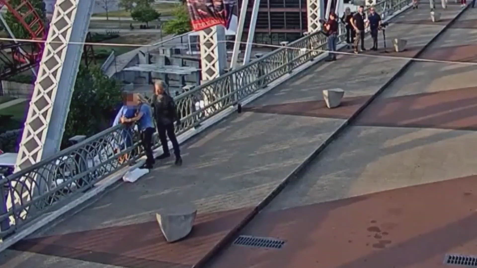 The rock star was shooting a video nearby and was captured on video with another woman who was helping to talk a woman off a bridge.