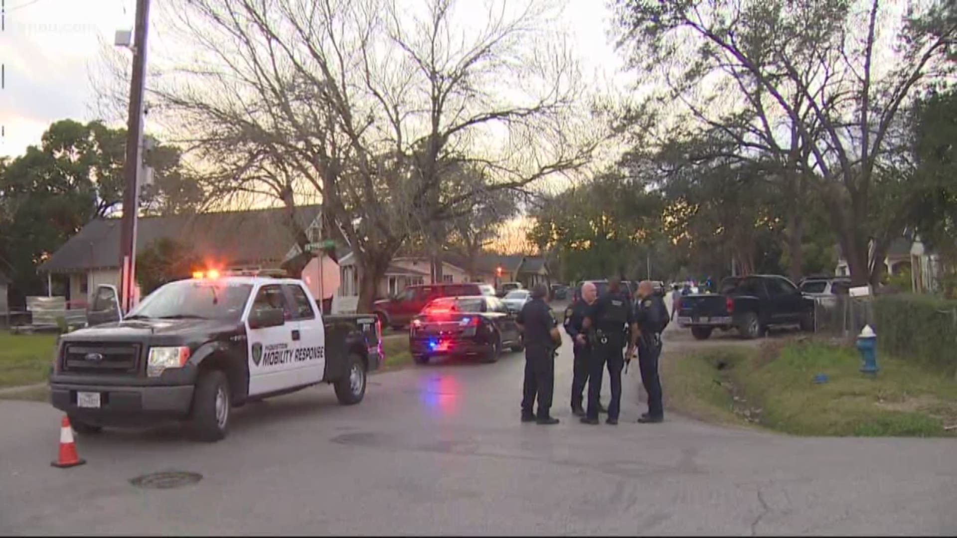 Officials say one suspect is dead and two others are barricaded inside a home after 5 officers were shot while serving a warrant in southeast Houston.