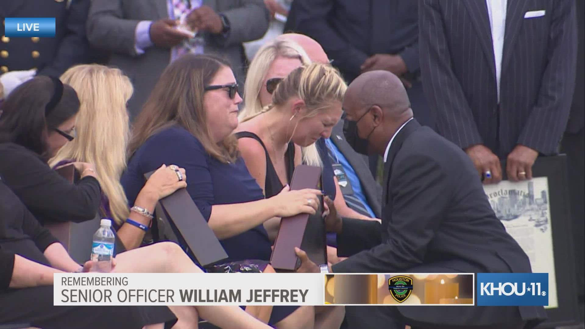A somber moment outside Grace Church as the family of HPD officer William Jeffrey accept the U.S. flag from his casket.