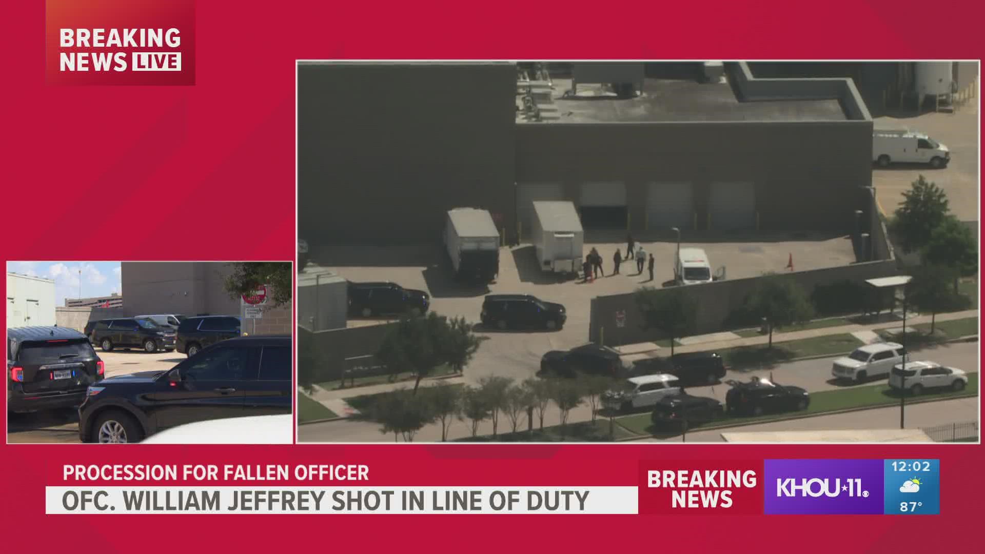 The body of fallen HPD officer William "Bill" Jeffery" arrives at medical examiner's office followed by police escort.