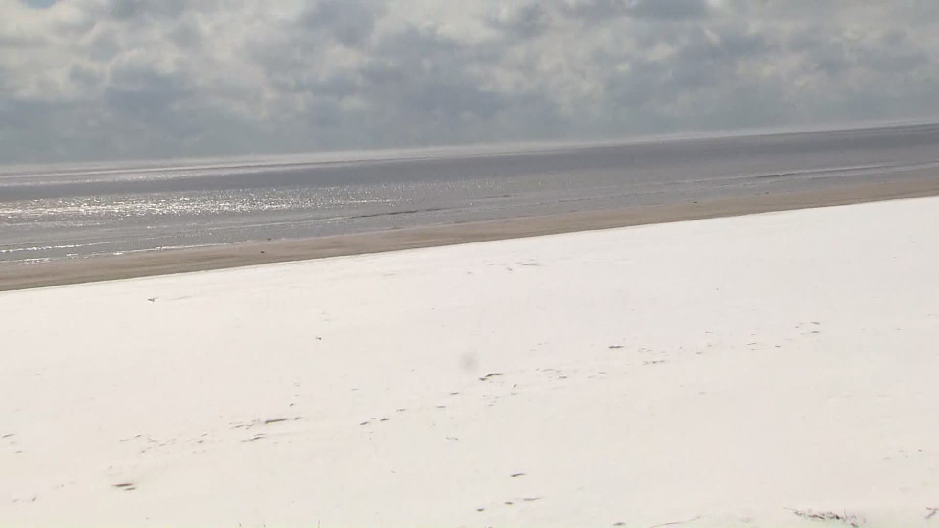 Galveston beach is covered in snow after an intense winter storm passed through the area. Many residents out enjoying the winter wonderland.