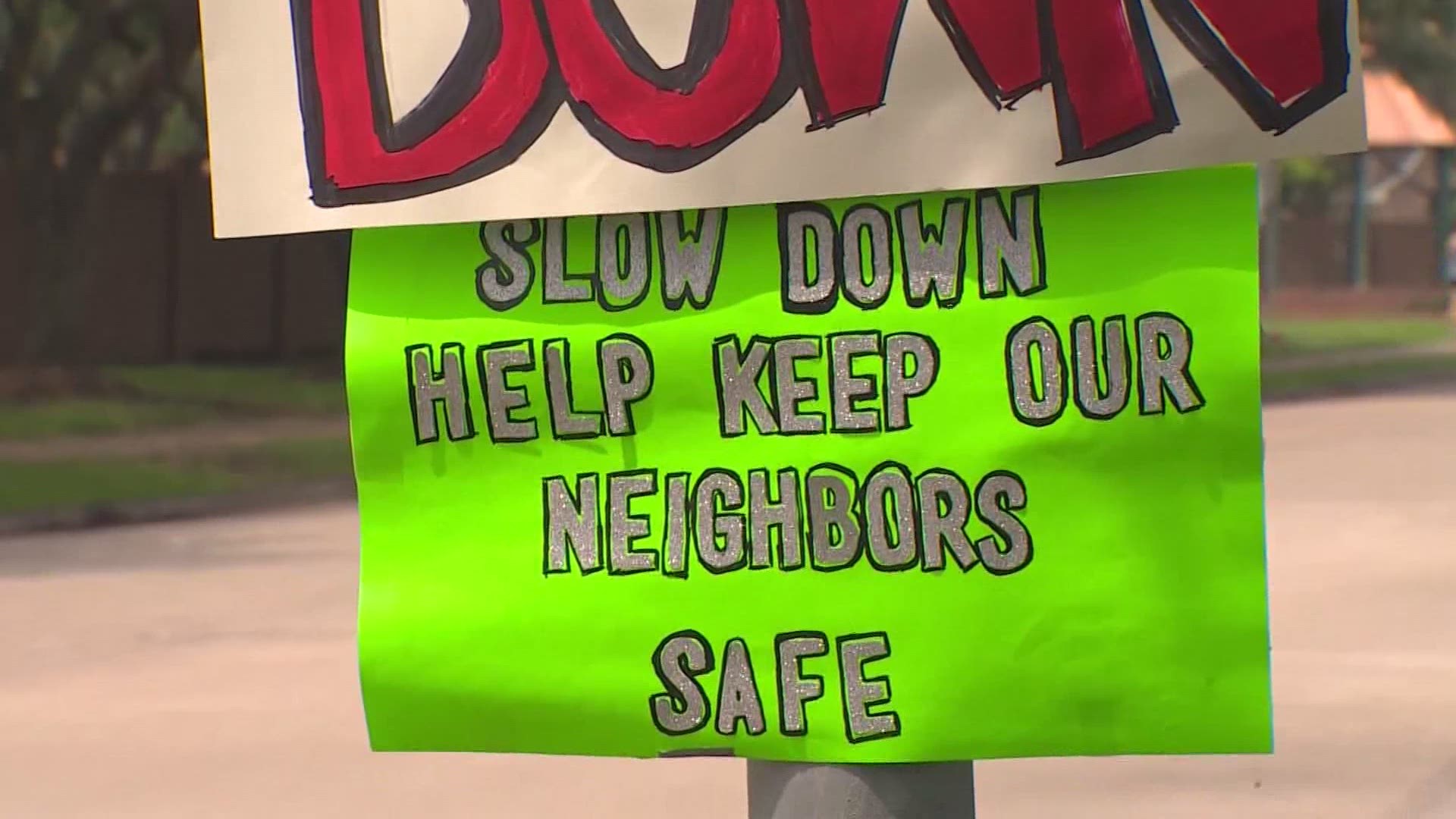 These Pearland neighbors are creating and posting handmade signs along Northfork Drive in an effort to get drivers to slow down.