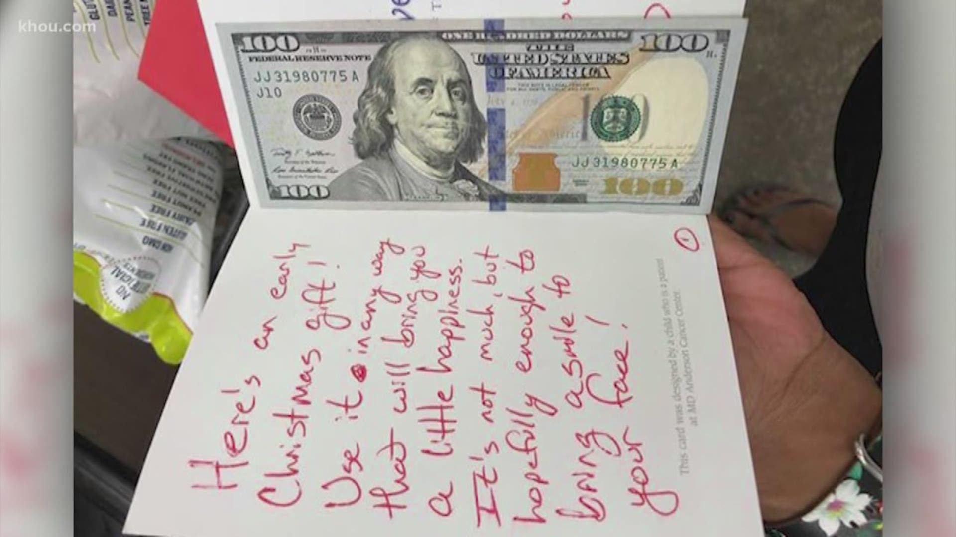 A woman shopping in a Cypress Kroger supermarket was gifted $100 from a random man in a red hoodie. He left the money in a card and wrote, "Here's an early Christmas gift!"