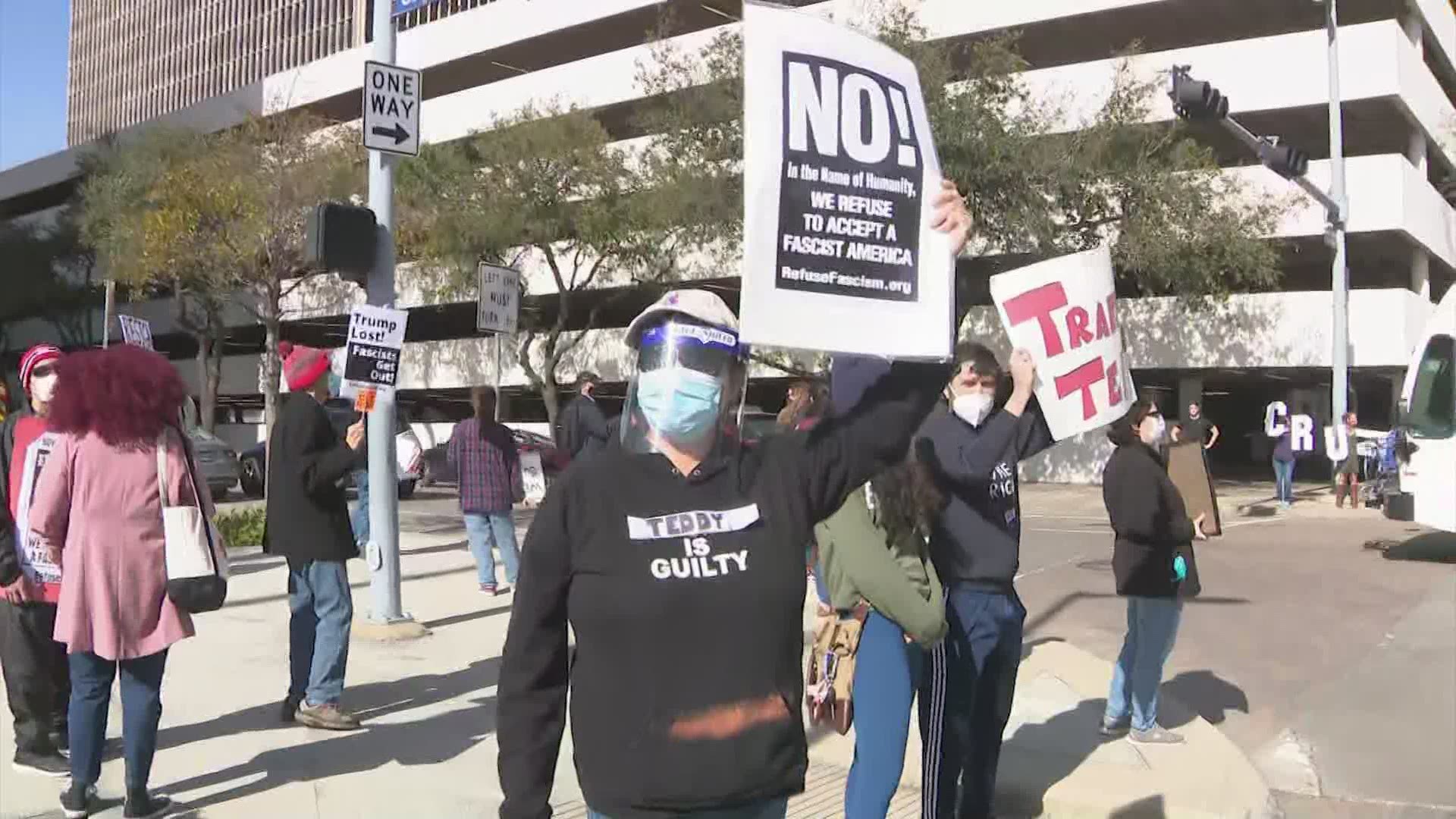 Protesters calling for Sen. Ted Cruz to resign gathered outside his office in downtown Houston Saturday.