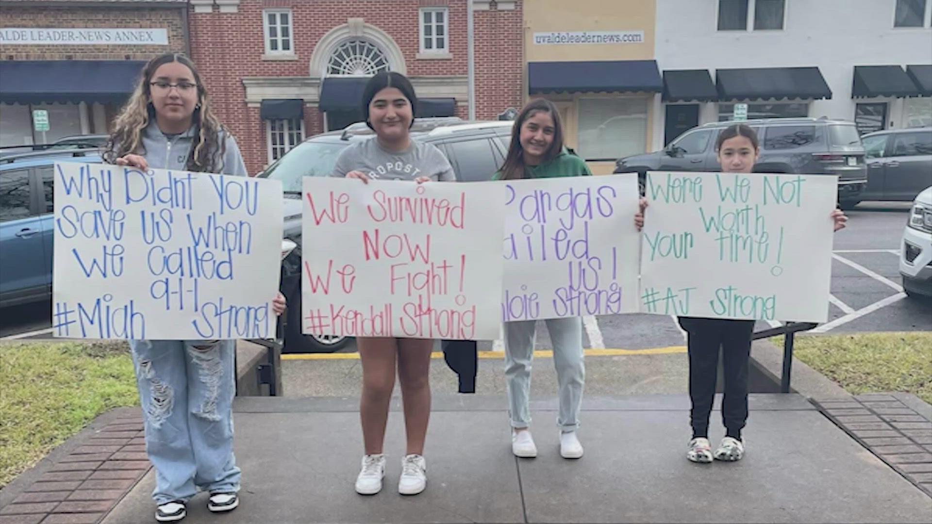 Powerful images have surfaced of four survivors holding up posters demanding the resignation of the law enforcement officers who failed to protect them.