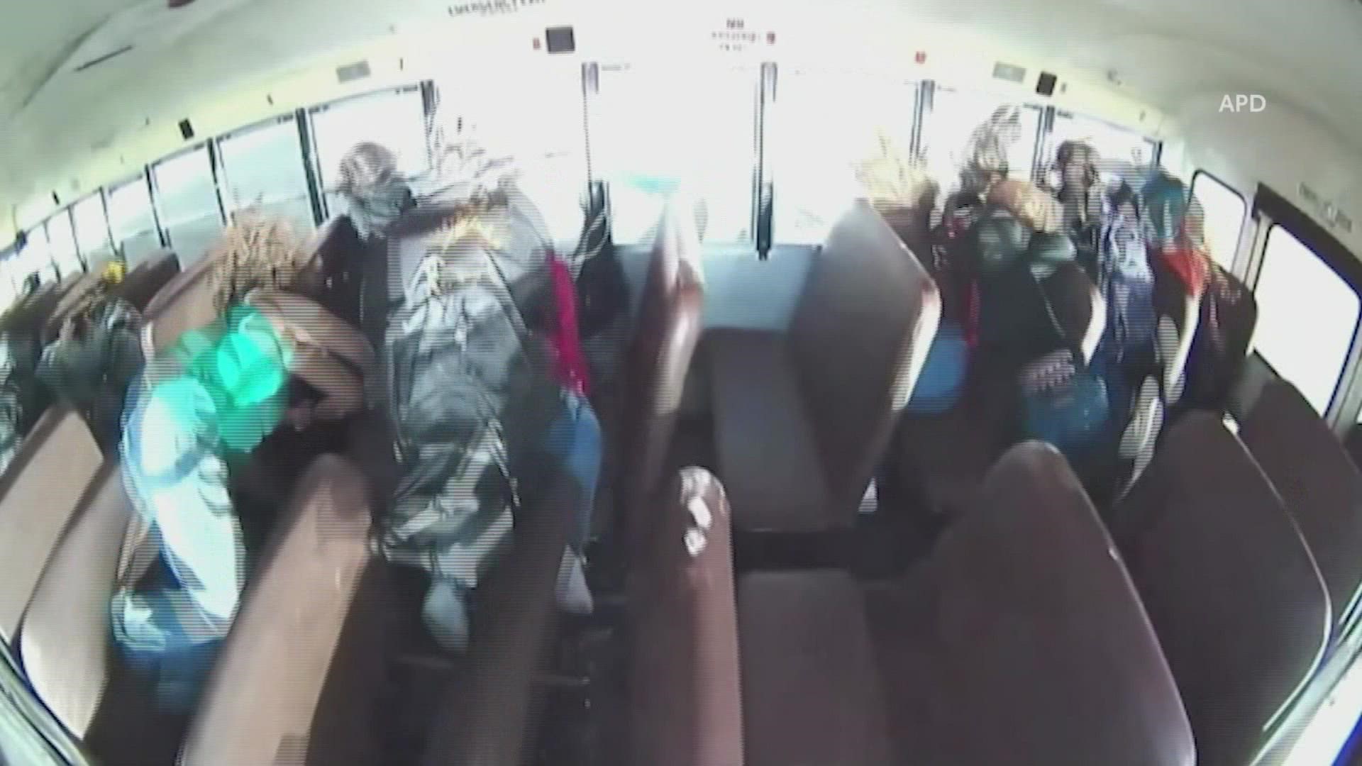 Video released by the Albuquerque Police Department showed the moment a racing car slammed into a school bus, causing it to turn on its side.
