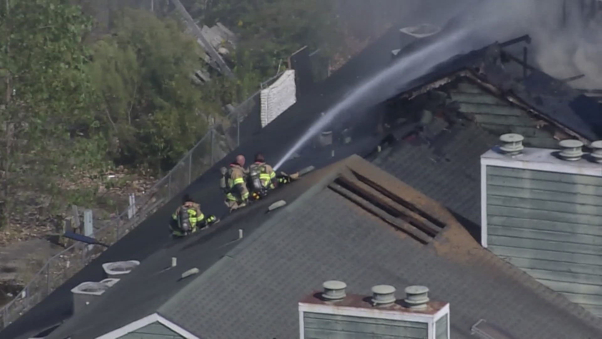 Authorities said a firefighter was injured after falling through the floor of a burning apartment complex in west Houston on Monday.