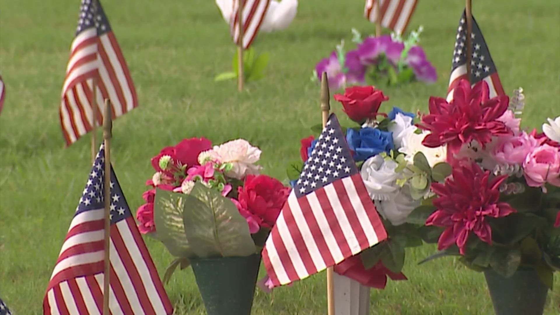 American flags were placed for each man and woman buried at the cemetery. Names and ranks were read aloud.