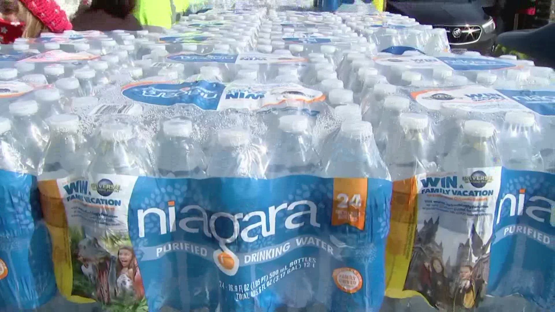 Officials say they handed out more than one million units of water Friday, and hundreds lined up for more on Saturday.