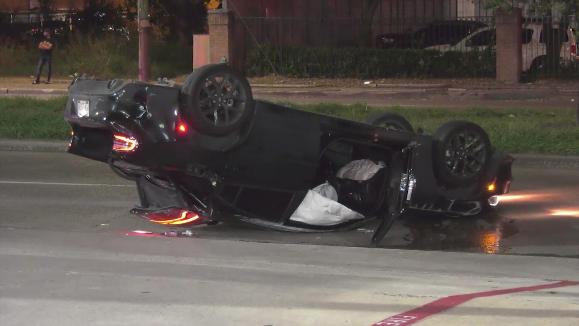 Police said the car struck a light pole before flipping and hitting a woman that was walking across the road.