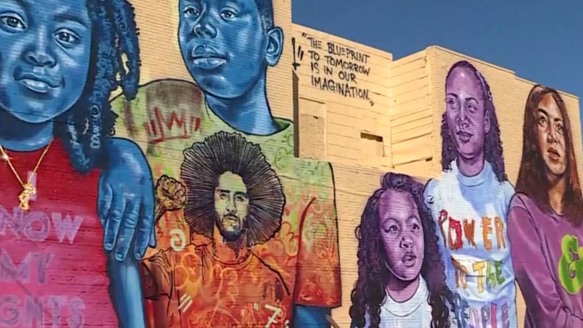 Here's Colin Kaepernick's parents in front of a statue of their