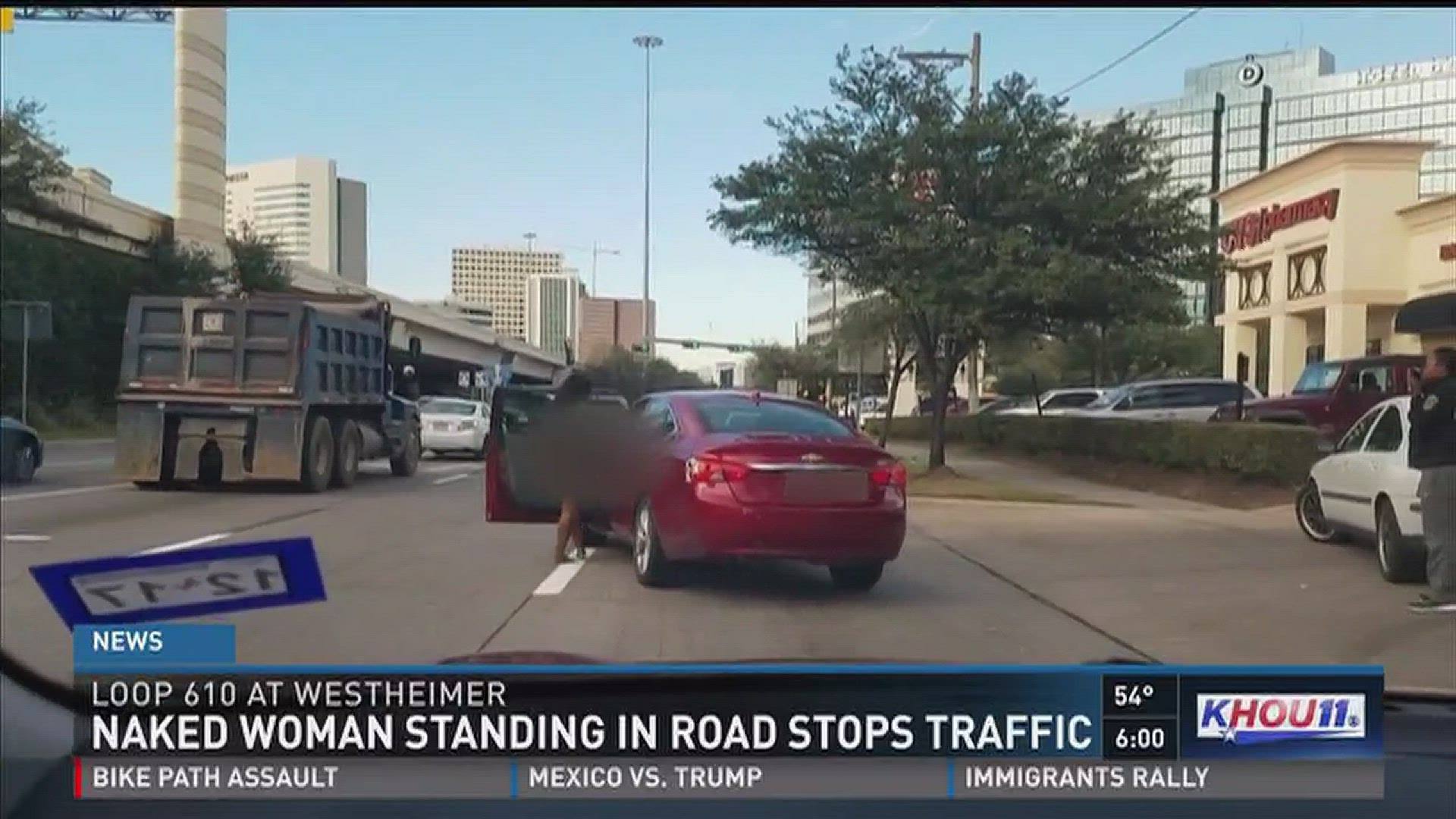 Naked woman standing in road stops traffic