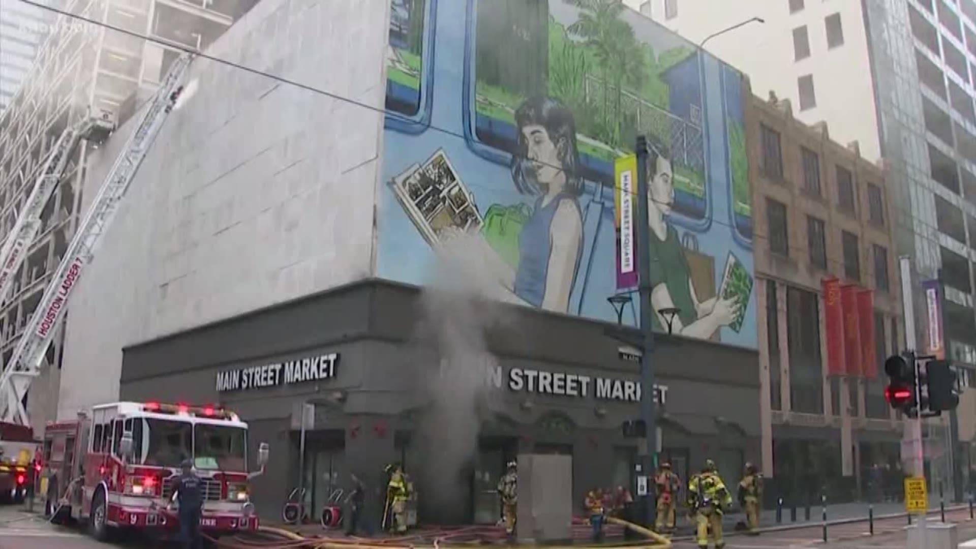 Houston fire officials say three firefighters were injured after battling a four-alarm fire at the Main Street Market in downtown Thursday morning.