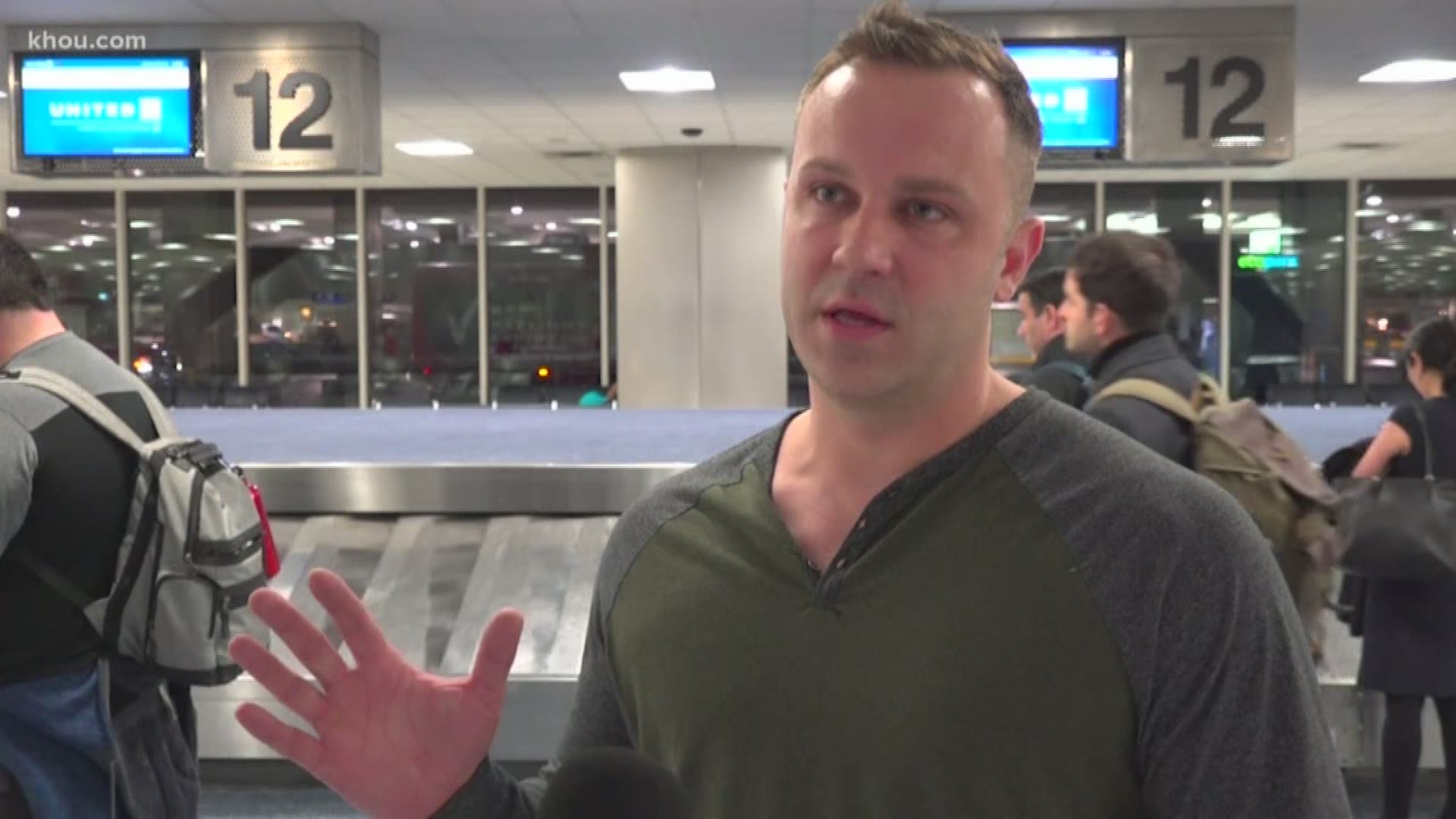 KHOU 11 reporter Adam Bennett talks to passengers on board the United plane that caught fire during a flight from New Jersey to Houston late Sunday.