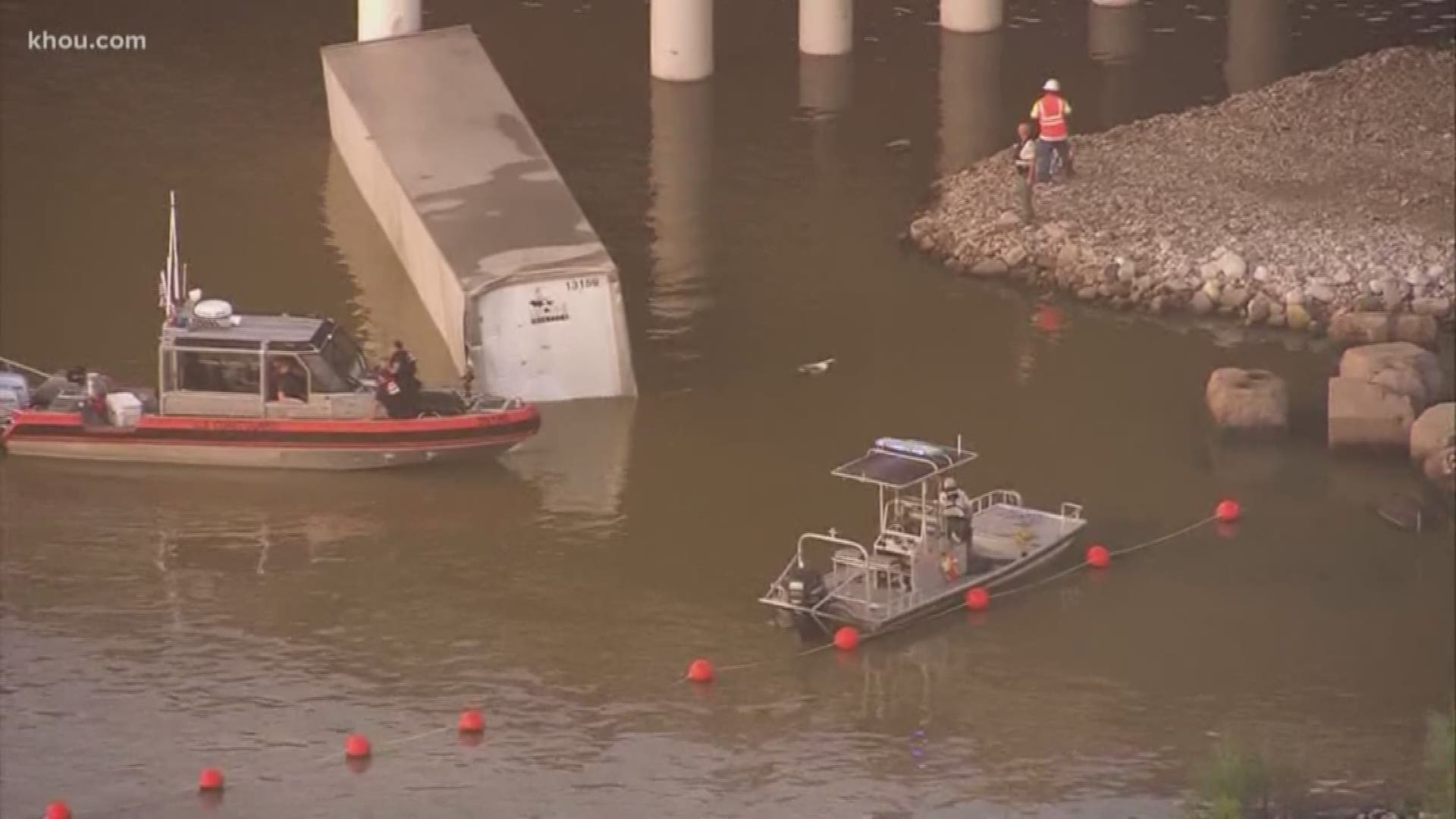 A big rig is still in the water in the San Jacinto River after a truck driver plummeted 20 feet to the murky water early Thursday morning.