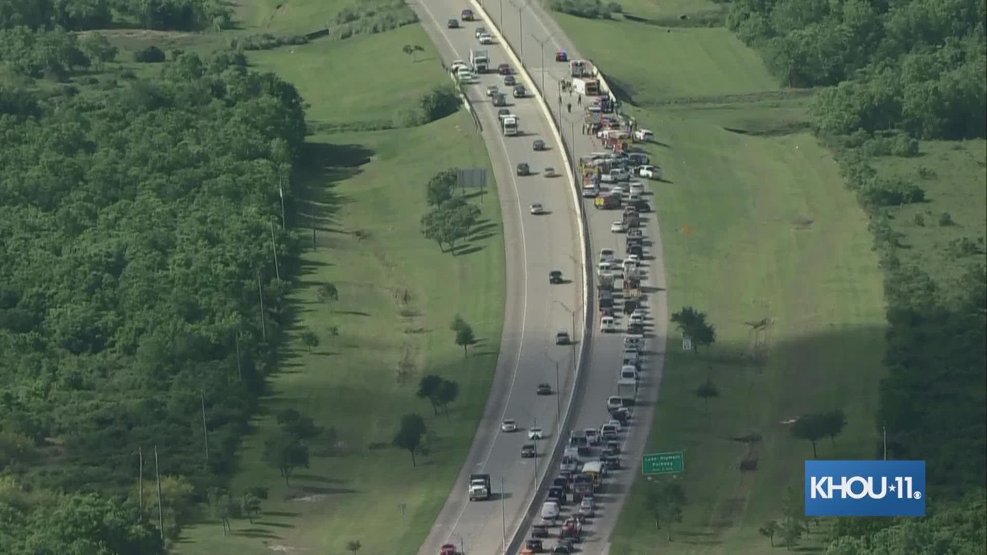 An overturned school bus is blocking traffic heading south on the Fort Bend Toll Road Friday morning.