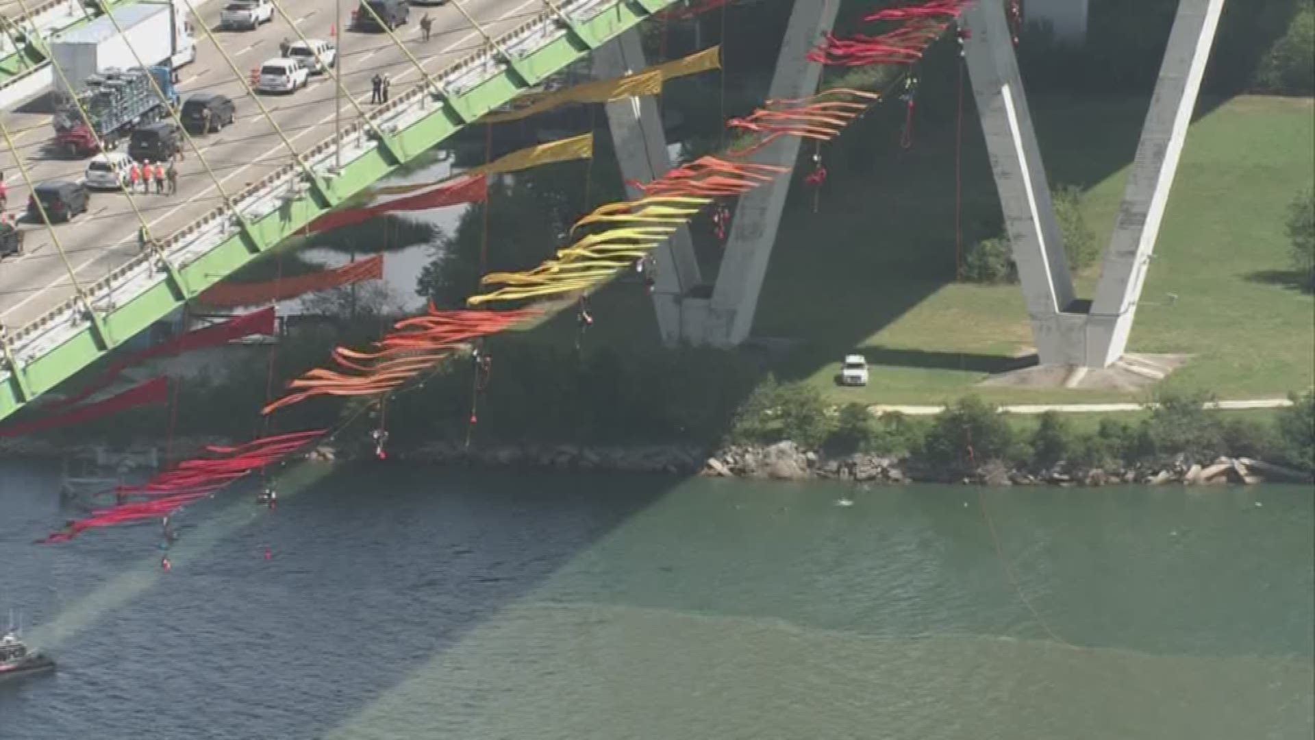 Greenpeace activists are hanging from the Fred Hartman Bridge in an effort to block traffic in the Houston Ship Channel.
