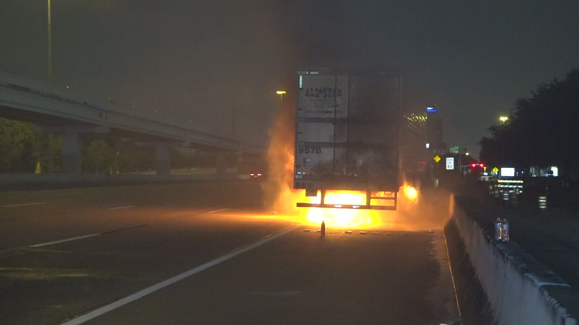 Firefighters work to put out a fire on a truck carrying jalapenos on the southwest freeway early Friday morning.