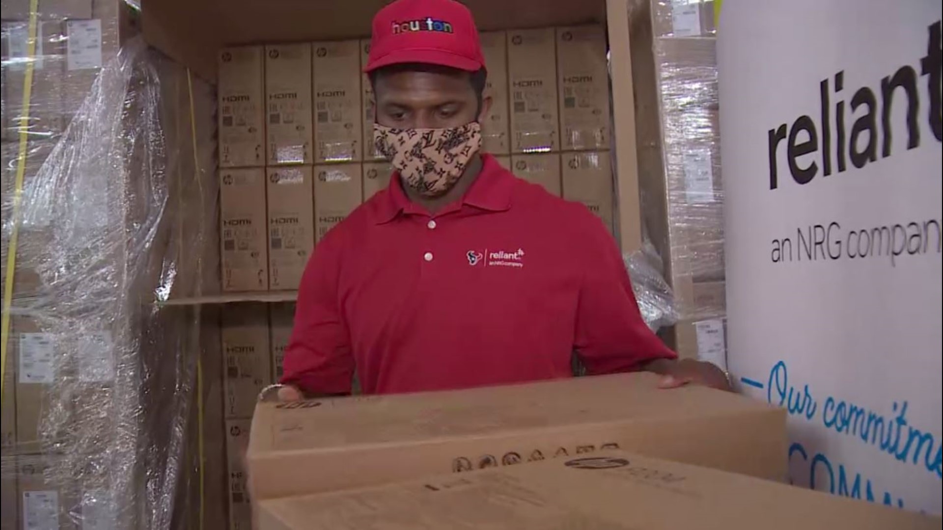 Houston Texans Deshaun Watson shuffled through boxes of computers— in a rare move – keeping out of the spotlight and to the sidelines of a computer giveaway.