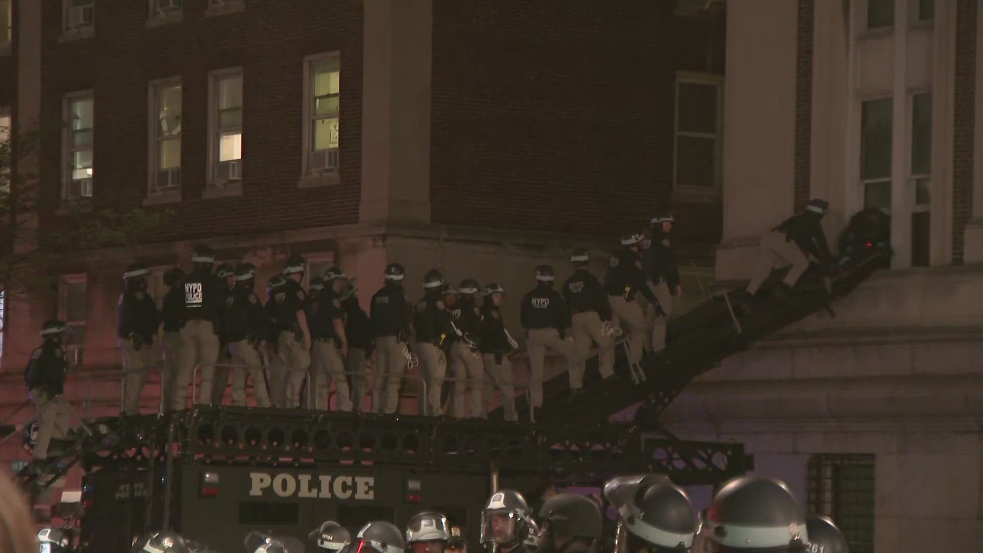 Columbia University issued a shelter-in-place order Tuesday evening as scores of police officers in riot gear swarmed near the New York campus.
