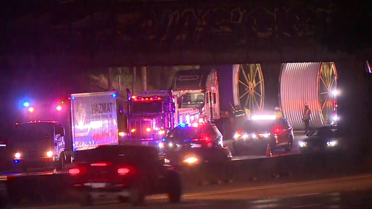 Traffic alert: Big rig carrying rolls of cable wedged under train trestle on East Freeway
