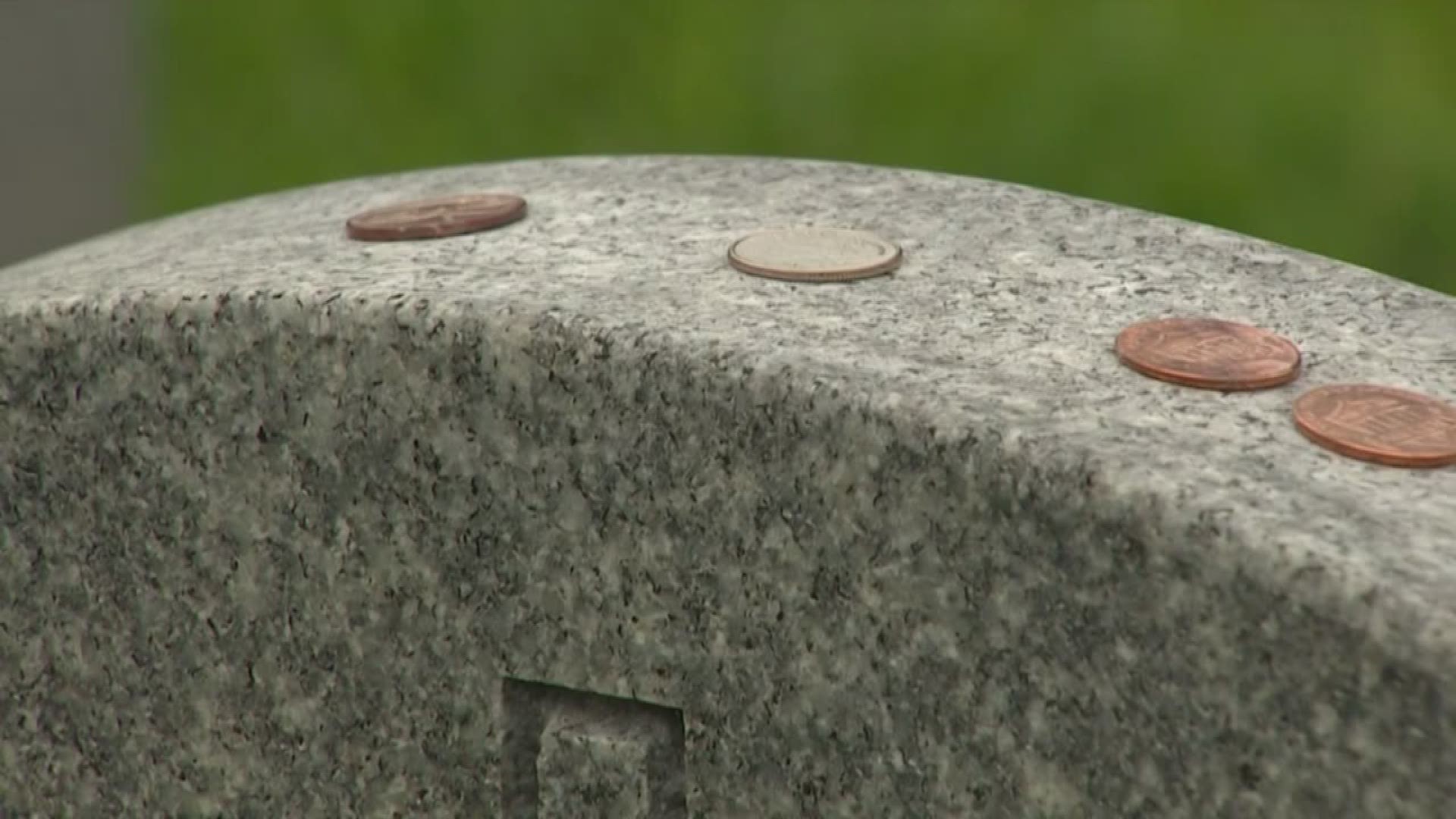 If you've spent time at a national cemetery, you may have noticed coins on some graves.