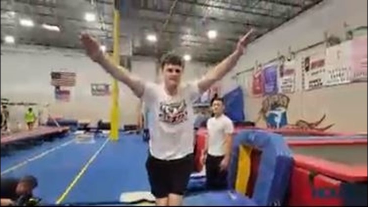 Special Olympian pushing himself on the gymnastics floor