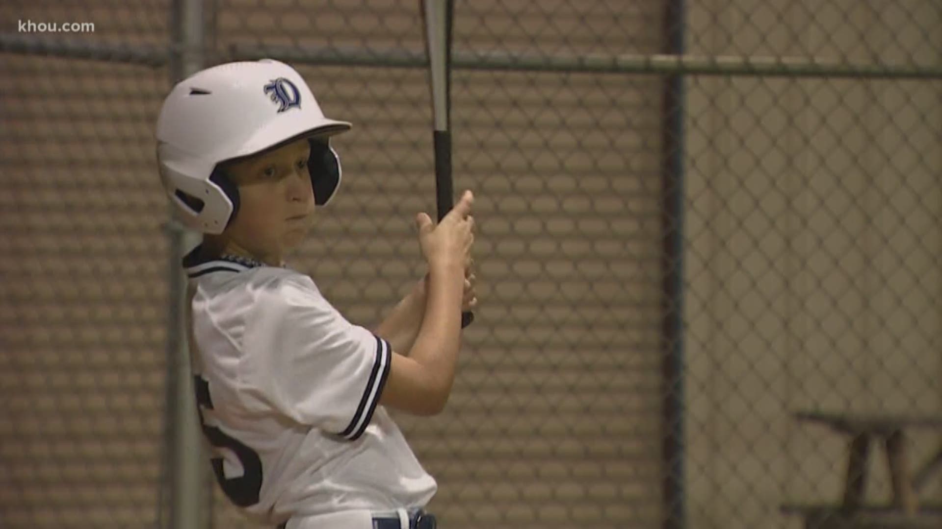 A young baseball player, born with three holes in his heart, is back on the field one month after having heart surgery.