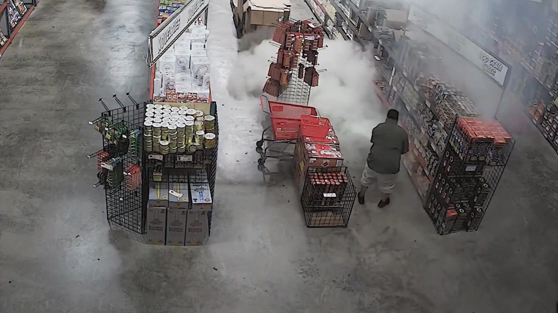 The search is on for three men seen on video lighting a firework inside a fireworks warehouse and then stealing $200 worth of products during the evacuation.