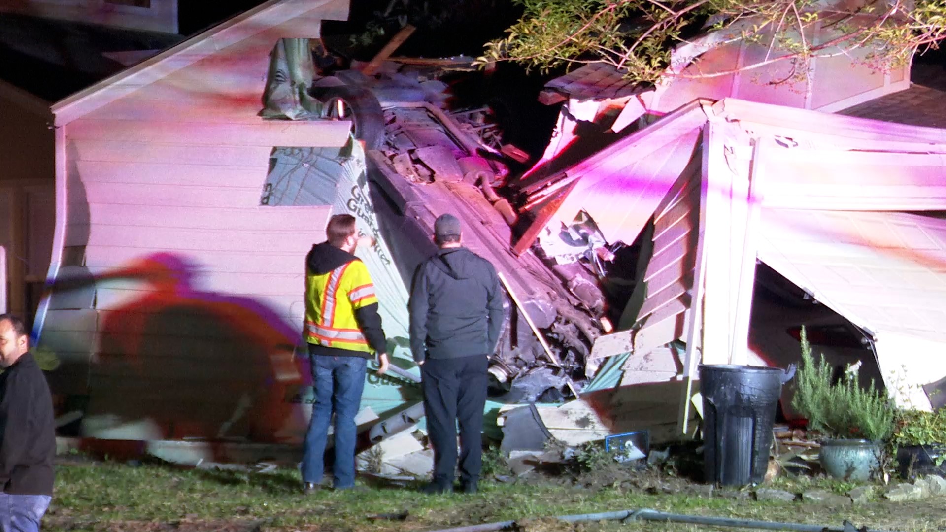 The car appeared to have flipped into the side of the garage, coming to rest vertically embedded into the wall.