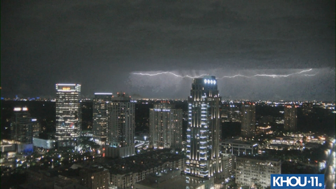 Bolt of lightning lights up night sky over Uptown Houston