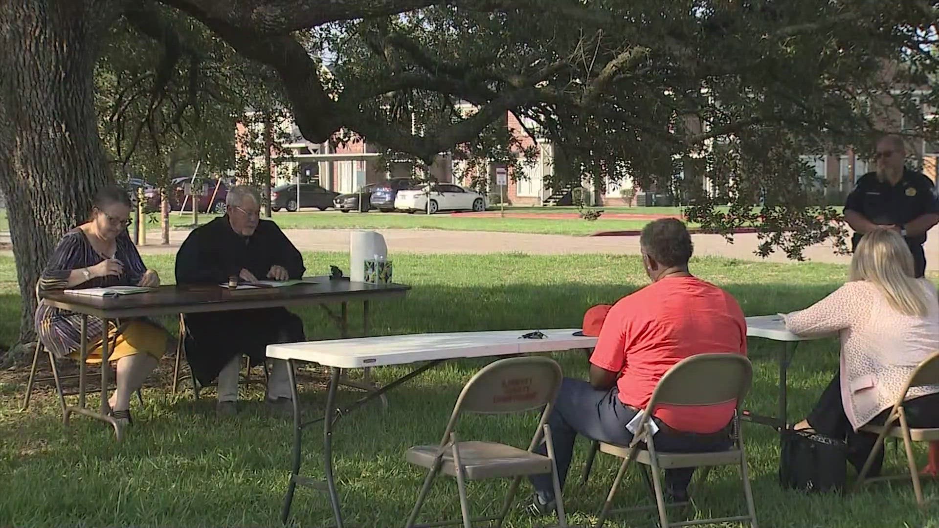 The was holding hearing under a tree because the annex where he normally holds court had flooded.
