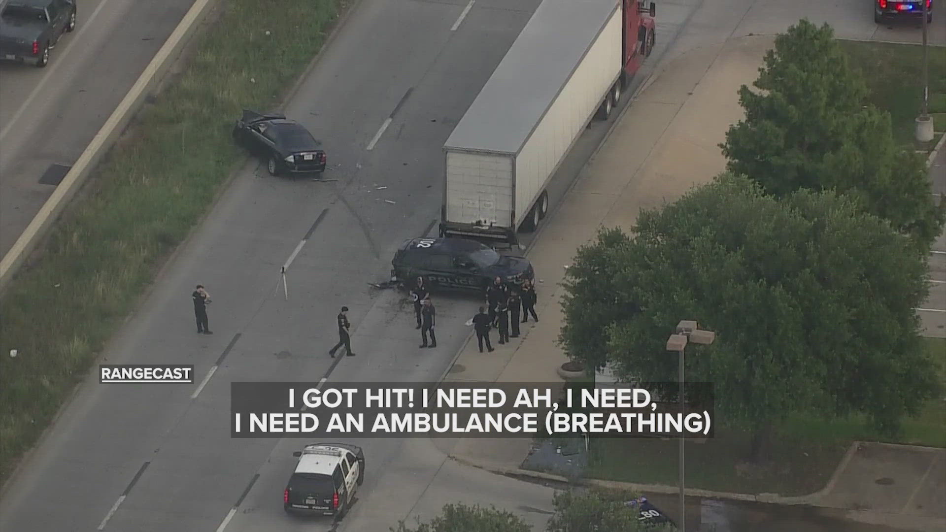 A Houston police officer is injured and trapped after a crash with an 18-wheeler on Highway 290.