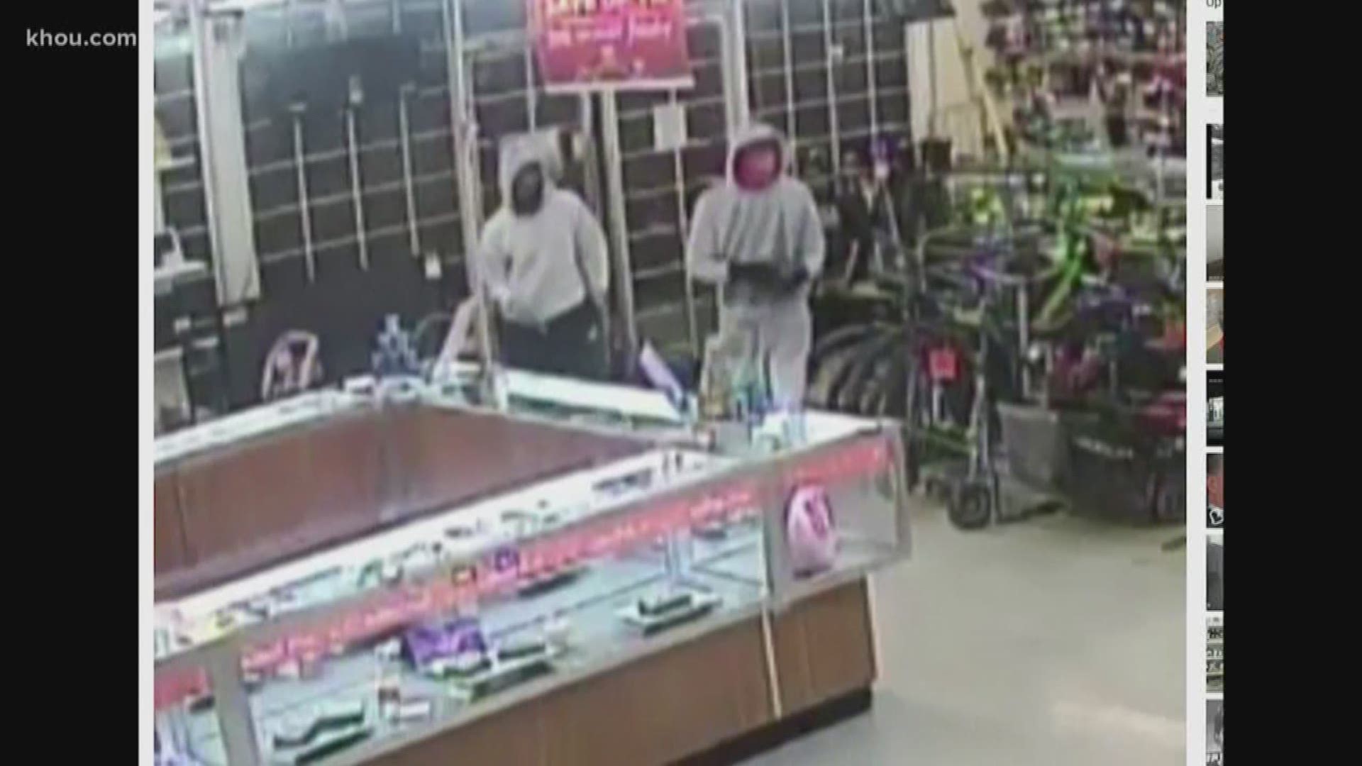 New video shows two robbery suspects storm into a pawn shop in southwest Houston. One of the suspects fatally shot a man who tried to stop them.