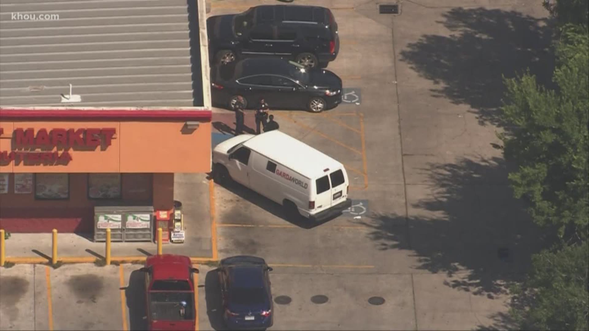 Deputies are looking for a suspect in an armored car robbery who used pepper spray on the victim before stealing cash, according to the Harris County Sheriff's Office.