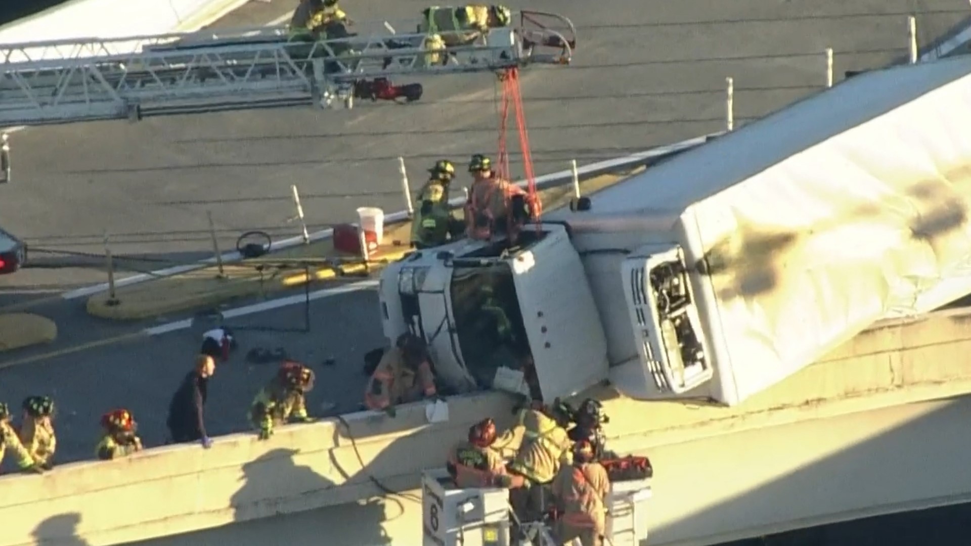 Video shows driver being rescued from box truck hanging off Houston ...