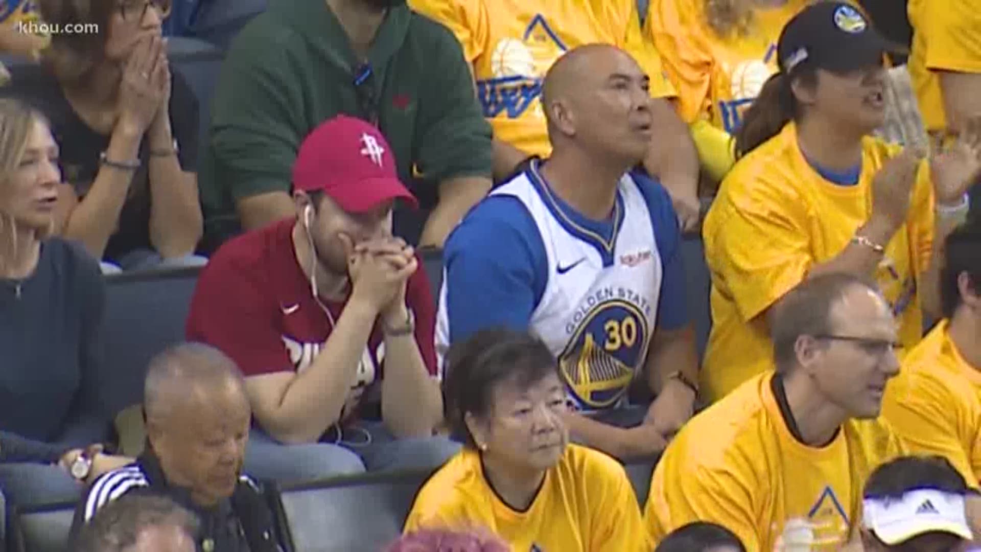 A die-hard Rockets fan who lives in Warrior's territory cheers on Houston in Game 1.