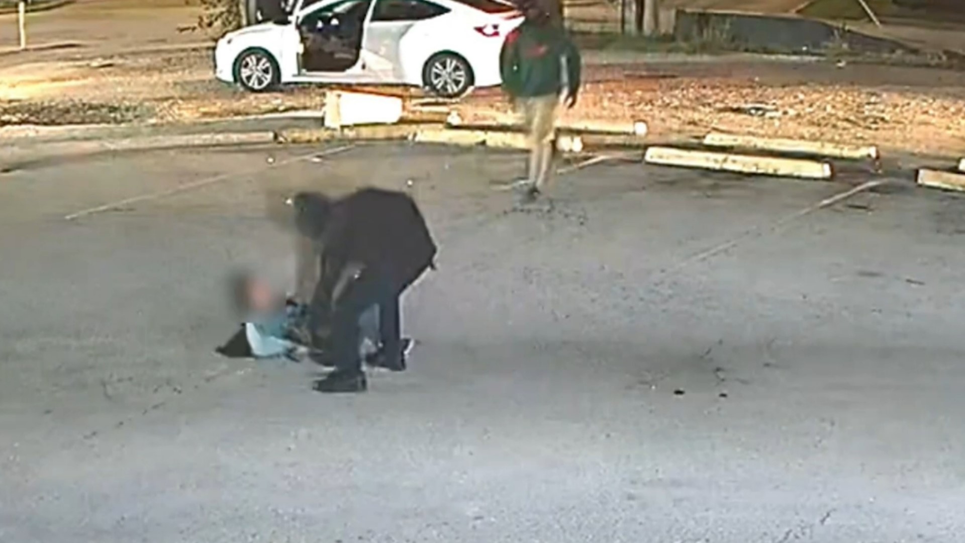 Video shows three men jump out of a car, knock her to the ground and steal from her.