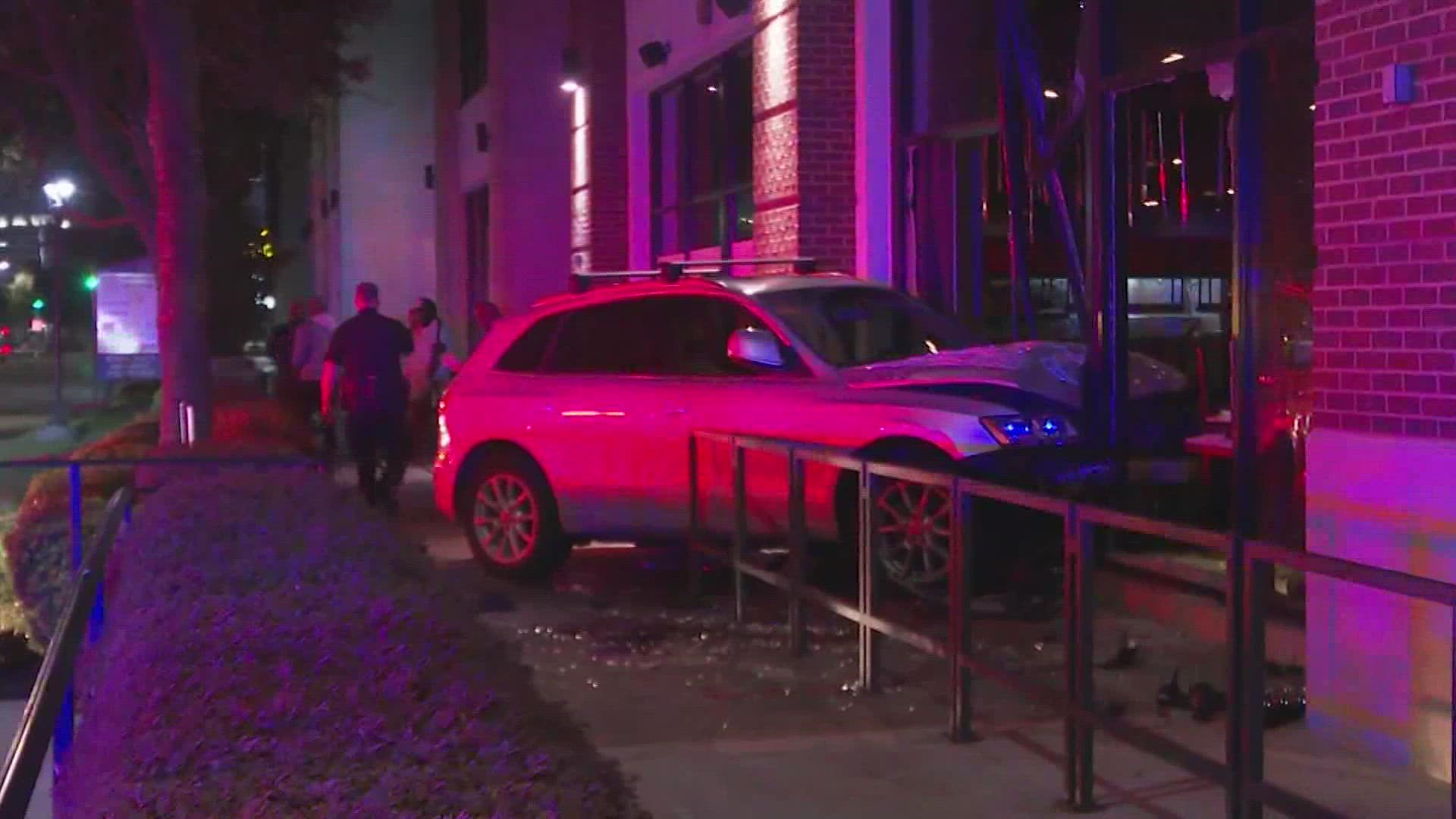 A woman crashed an SUV into a light pole and a restaurant in the River Oaks area early Tuesday.