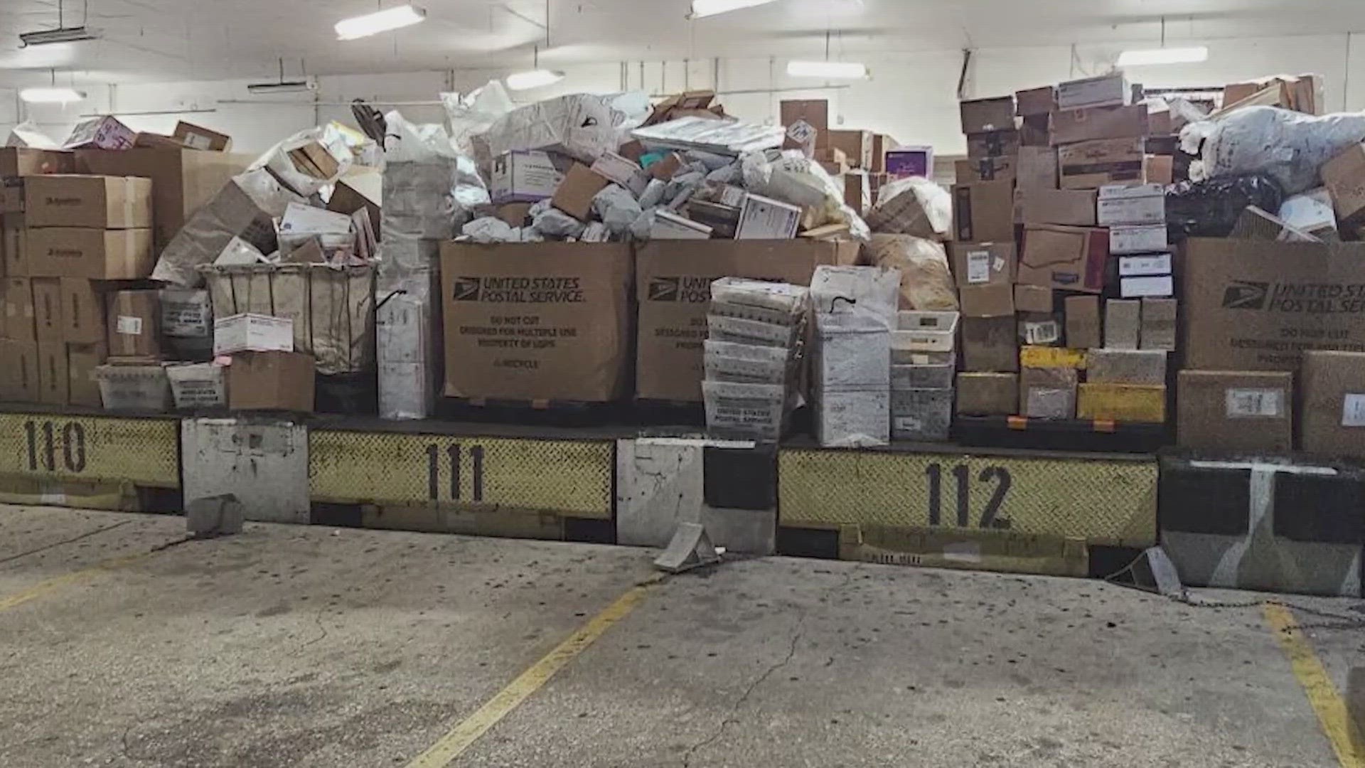 Photos show boxes of packages stacked up at Missouri City USPS Processing Center as delays continue.